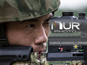 Special forces soldiers are performing an automatic rifle firing test on fixed targets in Baise, Guangxi province, China, on June 20, 2024....