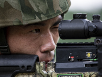 Special forces soldiers are performing an automatic rifle firing test on fixed targets in Baise, Guangxi province, China, on June 20, 2024....