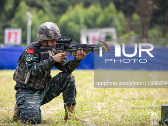 Special forces soldiers are performing an automatic rifle firing test on fixed targets in Baise, Guangxi province, China, on June 20, 2024....