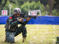 Special forces soldiers are performing an automatic rifle firing test on fixed targets in Baise, Guangxi province, China, on June 20, 2024....