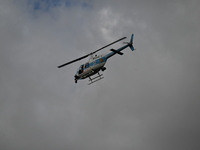 A police helicopter is hovering over the scene. A 31-year-old male is being shot in a shooting in Chicago, Illinois, United States, on June...