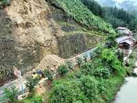 Workers are driving machinery and equipment to clear landslide soil at the site of a landslide in Datong Township on G242 National Highway i...