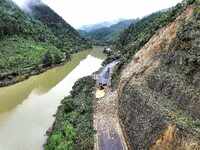 Workers are driving machinery and equipment to clear landslide soil at the site of a landslide in Datong Township on G242 National Highway i...