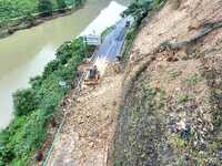 Workers are driving machinery and equipment to clear landslide soil at the site of a landslide in Datong Township on G242 National Highway i...