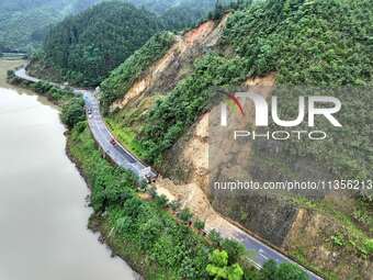 Workers are driving machinery and equipment to clear landslide soil at the site of a landslide in Datong Township on G242 National Highway i...