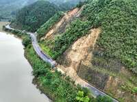 Workers are driving machinery and equipment to clear landslide soil at the site of a landslide in Datong Township on G242 National Highway i...