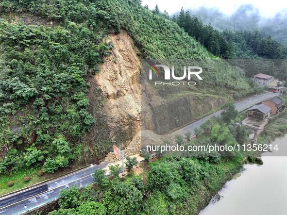 Workers are driving machinery and equipment to clear landslide soil at the site of a landslide in Datong Township on G242 National Highway i...