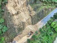 Workers are driving machinery and equipment to clear landslide soil at the site of a landslide in Datong Township on G242 National Highway i...