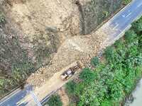 Workers are driving machinery and equipment to clear landslide soil at the site of a landslide in Datong Township on G242 National Highway i...