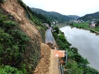 Workers are driving machinery and equipment to clear landslide soil at the site of a landslide in Datong Township on G242 National Highway i...