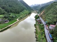 Workers are driving machinery and equipment to clear landslide soil at the site of a landslide in Datong Township on G242 National Highway i...