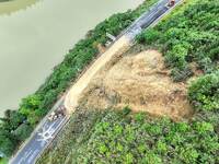 Workers are driving machinery and equipment to clear landslide soil at the site of a landslide in Datong Township on G242 National Highway i...