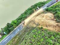 Workers are driving machinery and equipment to clear landslide soil at the site of a landslide in Datong Township on G242 National Highway i...