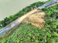 Workers are driving machinery and equipment to clear landslide soil at the site of a landslide in Datong Township on G242 National Highway i...