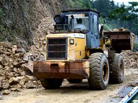 Workers are driving machinery and equipment to clear landslide soil at the site of a landslide in Datong Township on G242 National Highway i...