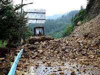 Workers are driving machinery and equipment to clear landslide soil at the site of a landslide in Datong Township on G242 National Highway i...