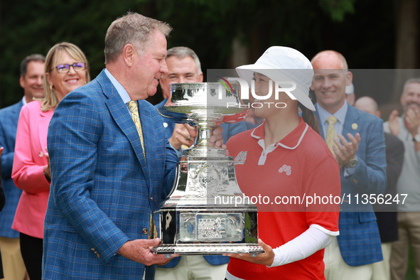 Amy Yang of Republic of Korea is presented with the trophy by the president of the PGA John Lindert after winning the KPMG Women's PGA Champ...