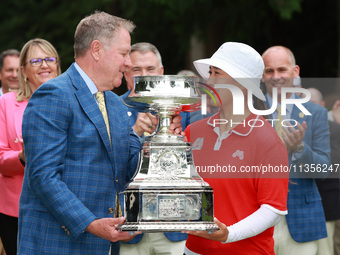 Amy Yang of Republic of Korea is presented with the trophy by the president of the PGA John Lindert after winning the KPMG Women's PGA Champ...