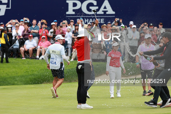 Amy Yang of Republic of Korea is showered with sparkling wine by her peers after winning the KPMG Women's PGA Championship at Sahalee Countr...