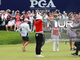 Amy Yang of Republic of Korea is showered with sparkling wine by her peers after winning the KPMG Women's PGA Championship at Sahalee Countr...