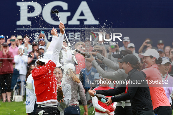 Amy Yang of Republic of Korea is showered with sparkling wine by her peers after winning the KPMG Women's PGA Championship at Sahalee Countr...