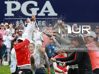 Amy Yang of Republic of Korea is showered with sparkling wine by her peers after winning the KPMG Women's PGA Championship at Sahalee Countr...