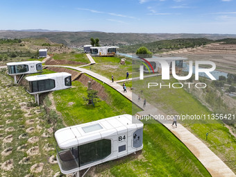 Tourists are playing at the ''space capsule camp'' in Ganjing village, Guyuan city, Northwest China's Ningxia Hui Autonomous region, on June...