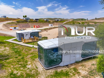 Tourists are playing at the ''space capsule camp'' in Ganjing village, Guyuan city, Northwest China's Ningxia Hui Autonomous region, on June...