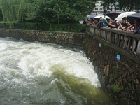 Tourists are watching the Shengtang Gate discharge water from the lake of West Lake in Hangzhou, China, on June 24, 2024. On the same day, t...