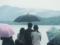 Tourists are braving the rain on the West Lake in Hangzhou, China, on June 24, 2024. On the same day, the National Meteorological Center is...