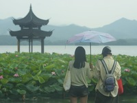 Tourists are braving the rain on the West Lake in Hangzhou, China, on June 24, 2024. On the same day, the National Meteorological Center is...