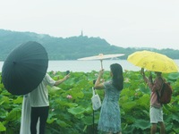 Tourists are braving the rain on the West Lake in Hangzhou, China, on June 24, 2024. On the same day, the National Meteorological Center is...