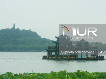 Tourists are braving the rain on the West Lake in Hangzhou, China, on June 24, 2024. On the same day, the National Meteorological Center is...