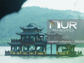 Tourists are braving the rain on the West Lake in Hangzhou, China, on June 24, 2024. On the same day, the National Meteorological Center is...