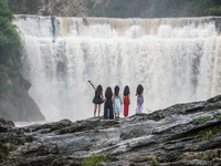 Tourists are enjoying cooling off at the Diaolan Waterfall in Xiangshui township of Bijie city, in Bijie, China, on June 23, 2024. (