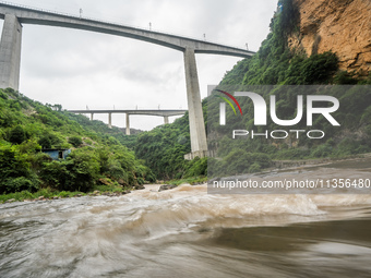 Tourists are enjoying cooling off at the Diaolan Waterfall in Xiangshui township of Bijie city, in Bijie, China, on June 23, 2024. (