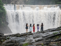 Tourists are enjoying cooling off at the Diaolan Waterfall in Xiangshui township of Bijie city, in Bijie, China, on June 23, 2024. (