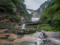 Tourists are enjoying cooling off at the Diaolan Waterfall in Xiangshui township of Bijie city, in Bijie, China, on June 23, 2024. (