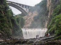 Tourists are enjoying cooling off at the Diaolan Waterfall in Xiangshui township of Bijie city, in Bijie, China, on June 23, 2024. (