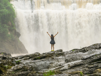 Tourists are enjoying cooling off at the Diaolan Waterfall in Xiangshui township of Bijie city, in Bijie, China, on June 23, 2024. (