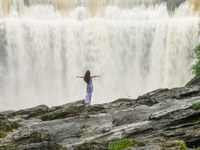 Tourists are enjoying cooling off at the Diaolan Waterfall in Xiangshui township of Bijie city, in Bijie, China, on June 23, 2024. (