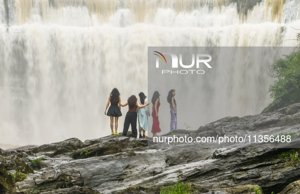 Tourists are enjoying cooling off at the Diaolan Waterfall in Xiangshui township of Bijie city, in Bijie, China, on June 23, 2024. 