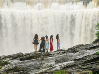 Tourists are enjoying cooling off at the Diaolan Waterfall in Xiangshui township of Bijie city, in Bijie, China, on June 23, 2024. (