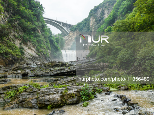 Tourists are enjoying cooling off at the Diaolan Waterfall in Xiangshui township of Bijie city, in Bijie, China, on June 23, 2024. 