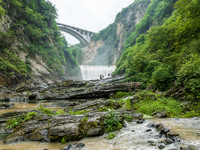 Tourists are enjoying cooling off at the Diaolan Waterfall in Xiangshui township of Bijie city, in Bijie, China, on June 23, 2024. (