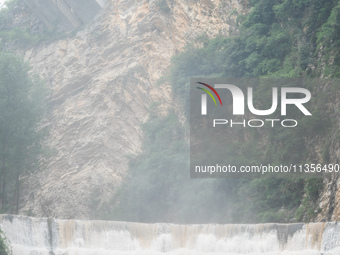 Tourists are enjoying cooling off at the Diaolan Waterfall in Xiangshui township of Bijie city, in Bijie, China, on June 23, 2024. (