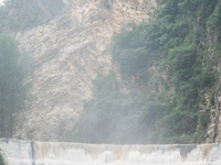 Tourists are enjoying cooling off at the Diaolan Waterfall in Xiangshui township of Bijie city, in Bijie, China, on June 23, 2024. (