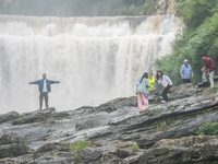 Tourists are enjoying cooling off at the Diaolan Waterfall in Xiangshui township of Bijie city, in Bijie, China, on June 23, 2024. (