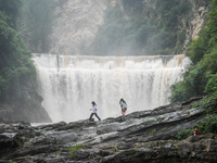 Tourists are enjoying cooling off at the Diaolan Waterfall in Xiangshui township of Bijie city, in Bijie, China, on June 23, 2024. (