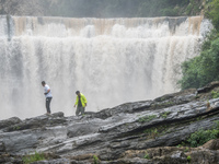 Tourists are enjoying cooling off at the Diaolan Waterfall in Xiangshui township of Bijie city, in Bijie, China, on June 23, 2024. (